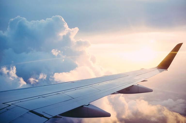 Heimflug, Flugzeug Flügel über den Wolken